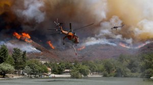 Firefighting helicopters battle the Blue Cut Fire as it burns out of control around the community of Lytle Creek. (Credit: Luis Sinco / Los Angeles Times) 