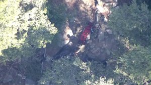 Authorities removed the body of one of the crash victims on Aug. 2, 2016. (Credit: KTLA)