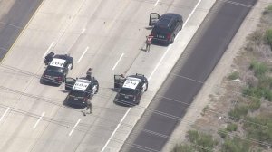 A driver surrenders on the 5 Freeway in San Diego County after a chase that lasted some two hours on Aug. 1, 2016. (Credit: KTLA)