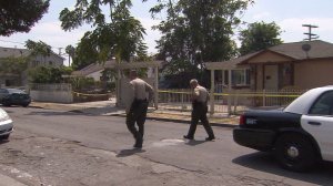 Los Angeles County Sheriff's Department officials investigate the death of a 71-year-old man in Compton on Aug. 27, 2016. (Credit: KTLA)