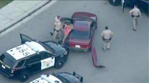 A driver was taken into custody when a pursuit came to an end in northern San Diego County on Aug 1, 2016. (Credit: KTLA}