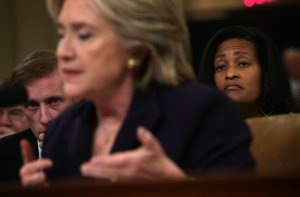 Democratic presidential candidate and former Secretary of State Hillary Clinton testifies before the House Select Committee on Benghazi as Jake Sullivan, left, Clinton's top foreign policy campaign adviser and her deputy chief of staff at the State Department, and Cheryl Mills, right, Clinton's chief of staff at the State Department, look on Oct. 22, 2015. (Credit: Alex Wong/Getty Images)