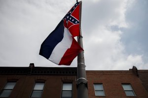 The Mississippi state flag, which features the Confederate flag, hangs as protestors gathered for a sit in, demanding its removal during a protest at the 2016 Democratic National Convention on July 25, 2016 in Philadelphia, Pennsylvania. (Credit: PATRICK T. FALLON/AFP/Getty Images)