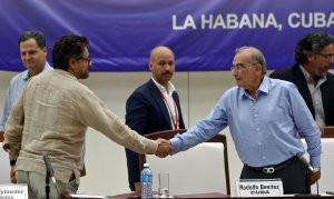 The head of the Colombian government delegation to the peace talks with the FARC leftist guerrillas shake hands during a press conference at Convention Palace in Havana, on Aug. 5, 2016. (Credit: YAMIL LAGE/AFP/Getty Images)