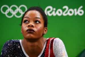 Gabrielle Douglas of the United States looks on during the Artistic Gymnastics Women's Team Final on Day 4 of the Rio 2016 Olympic Games in Rio de Janeiro, Brazil. (Credit: Laurence Griffiths/Getty Images)