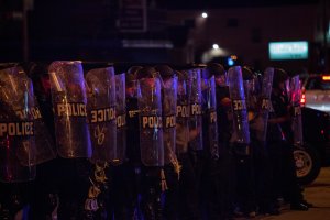 Police in riot gear line up as angry crowds took to the streets for a second night to protest an officer-involved killing August 14, 2016 in Milwaukee, Wisconsin. (Credit: Darren Hauck/Getty Images)