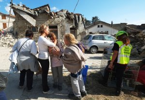 Women cry in front of damaged houses in a street in the central Italian village of Illica, near Accumoli, on Aug. 24, 2016 after a powerful earthquake rocked central Italy leaving at least 159 dead and hundreds more injured. (Credit: Mario Laporta/Getty Images)