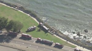 Firefighters respond at the edge of Point Fermin Park, where a young woman fell to her death on Aug. 19, 2016. (Credit: KTLA)