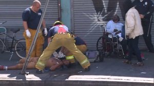 Los Angeles firefighters respond to a presumed overdose, treated one of 18 patients assessed, in Skid Row on Aug. 22, 2016. (Credit: KTLA)
