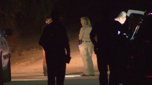 Homicide investigators are seen in Lebec after a woman's body was discovered on Aug. 14, 2016. (Credit: KTLA)