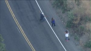 Distraught family members gather at crash site on Angeles Crest Highway on Aug. 1, 2016. (Credit: KTLA)