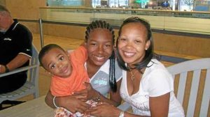 Ariana Washington (center) is seen in a family photo with her little brother Gabe, and mother, Euna.