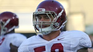 USC linebacker Osa Masina looks on from the sideline during a fall training camp practice in the Coliseum on Aug. 8. (Credit: Shotgun Spratling / Los Angeles Times)