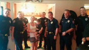 Terra Hubbard and her son Brayden pose with Yukon Police officers on Aug. 9, 2016. (Credit: KFOR)