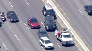 An SUV involved in a police chase on the 101 Freeway in the Topanga area managed to maneuver away from CHP officers after being boxed in by other cars on Aug. 1, 2016. (Credit: KTLA) 