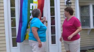 A Massachusetts community rallied behind a gay couple who had their pride rainbow flag stolen from their house. (Credit: WCVB via CNN)
