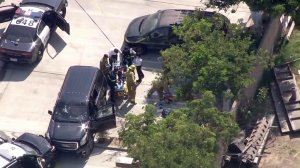 Paramedics treat one person after an officer-involved shooting in Lawndale on Aug. 2, 2016. (Credit: KTLA)