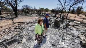 Miguel and Mabel Ramos, both 73, survey the devastation of the Blue Cut fire after it swept through their Oak Hills residence. (Credit: Irfan Khan / Los Angeles Times) 