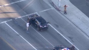 Two men allegedly spotted carrying rifles in Inglewood were taken into custody following a traffic stop in Lakeview Terrace on Aug. 16, 2016. (Credit: KTLA)