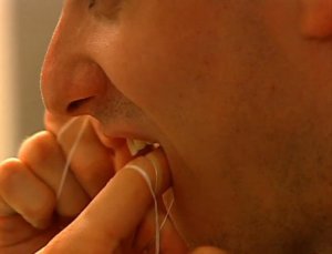 A file photo from 2013 shows a man flossing. (Credit: CNN)