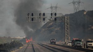 Fire burns on the train tracks near Interstate 15 at Keenbrook in San Bernardino County. (Credit: Marcus Yam/ Los Angeles Times) 