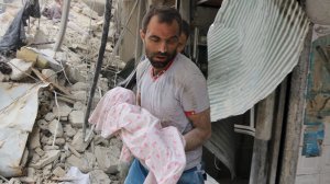A Syrian man carries the body of an infant retrieved from under the rubble of a building following a reported airstrike on September 23, 2016, in the northern Syrian city of Aleppo. (Credit: Thaer Mohammed/AFP/Getty Images)