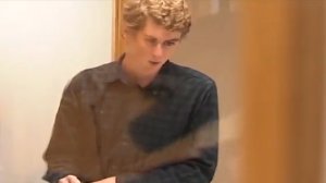 Brock Turner, seen behind glass, registers as a sex offender in Xenia, Ohio, on Sept. 6, 2016. (Credit: WHIO via CNN)