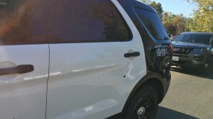 Los Angeles Police officials released this photo of a bullet hole in the back driver's side door of a patrol vehicle that was shot by an unknown gunman on Sept. 11, 2016.