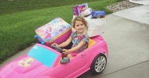 A Facebook photo shows Becca VanZyll of Hudsonville Michigan with toys loaded in her Barbie car for neighbors who lost everything in a fire.