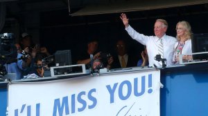 Dodgers announcer Vin Scully, with wife Sandi, waves to the fans after the team's 10th-inning victory over the Colorado Rockies on Sept. 25, 2016. (Luis Sinco/Los Angeles Times)