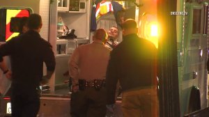 A man suspected of stabbing a woman in East Los Angeles is taken into custody and placed in an ambulance on Sept. 7, 2016 (Credit: OnScene.TV)