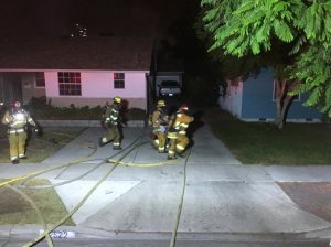 Firefighters are seen rescuing a woman from a home on Sept. 2, 2016, in a photo provided by the Garden Grove Fire Department. 