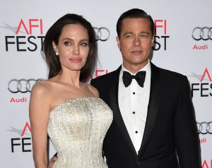 Writer-director-producer-actress Angelina Jolie Pitt and actor-producer Brad Pitt arrive for the opening night gala premiere of Universal Pictures' "By the Sea" at the TCL Chinese Theatre in Hollywood on Nov. 5, 2015. (Credit: MARK RALSTON/AFP/Getty Images)