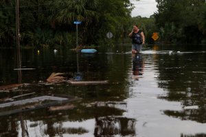 Lynne Garrett speaks to loved ones on the phone as she surveys damage outside of her home from the winds and storm surge associated with Hurricane Hermine which made landfall overnight in the area on September 2, 2016 in Tampa, Florida. (Credit: Brian Blanco/Getty Images)