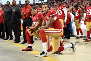 Colin Kaepernick and Eric Reid of the San Francisco 49ers kneel in protest during the national anthem prior to playing the Los Angeles Rams in their NFL game at Levi's Stadium on Sept. 12, 2016, in Santa Clara, California. (Credit: Thearon W. Henderson/Getty Images)