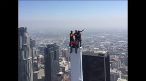 Construction workers take a picture on top of the Grand Wilshire Tower as it becomes the tallest building on the West Coast on Sept. 3, 2016. (Credit:KTLA)