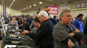 Gun enthusiasts view AR-15 semiautomatic assault rifle upper receiver parts and kits, which are legal in California, at the Crossroads of the West Gun Show in Del Mar. (Credit: Allen J. Schaben/Los Angeles Times)