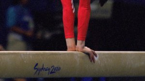 A U.S. gymnast performs on the balance beam during the 2000 Olympics in Sydney, Australia. (Credit: Mike Powell /Getty Images)