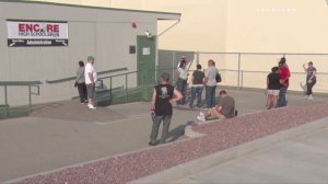 Parents and students wait outside a classroom at Encore High School where the San Bernardino County Sheriff's Department addressed a threat made to the school by a student. (Credit: LOUDLABS)
