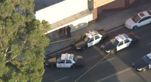 Police converge at an apartment complex in Long Beach after a man was found dead and a woman was injured in a shooting on Sept. 14, 2016. (Credit: KTLA)
