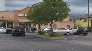 A parking enforcement vehicle remains in the parking lot of an East San Gabriel McDonald's where a man who allegedly stole it later died. (Credit: KTLA)
