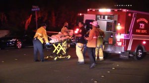 Firefighters treat a victim after a stabbing at a house party in Pasadena on Sept. 24, 2016. (Credit: Loudlabs News)