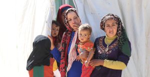 Syrian refugees stand at the Zaatari refugee camp, located close to the northern Jordanian city of Mafraq near the border with Syria, on July 14, 2016. (Credit: Khalil Mazraawi / AFP / Getty Images)