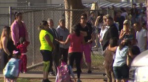 Parents and children stand near Indian Hills Elementary on Sept. 6, 2016. (Credit: KTLA)