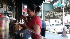 A woman eats at a taco stand in Queens, New York City, on Aug. 29, 2016. (Credit: Spencer Platt/Getty Images)