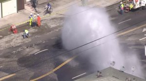 Water gushed onto Western Avenue after a main broke in South L.A. on Sept. 7, 2016. (Credit: KTLA)