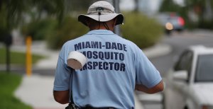 Carlos Varas, a Miami-Dade County mosquito control inspector, walks through the streets looking for places that might hold breeding mosquitos that are carrying the Zika virus on Sept. 2, 2016 in Miami Beach, Florida. (Credit: Joe Raedle/Getty Images)