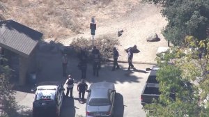 Police, firefighters and a state wildlife warden respond Oct. 10, 2016, to a possible bear attack at Bailey Canyon park in Sierra Madre. (Credit: KTLA)