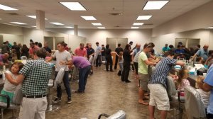 Father, stepfathers and grandfathers huddle over their daughters during a Daddy Daughter Hair Factory event in Daytona Beach, Florida. (Credit: CNN Wire)