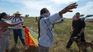 A Native American protestors holds up his arms as he and other protestors are threatened by private security guards and guard dogs, at a work site  for the Dakota Access Pipeline (DAPL) oil pipeline, near Cannon Ball, North Dakota, September 3, 2016.   (Credit: Robyn Beck/AFP/Getty Images)